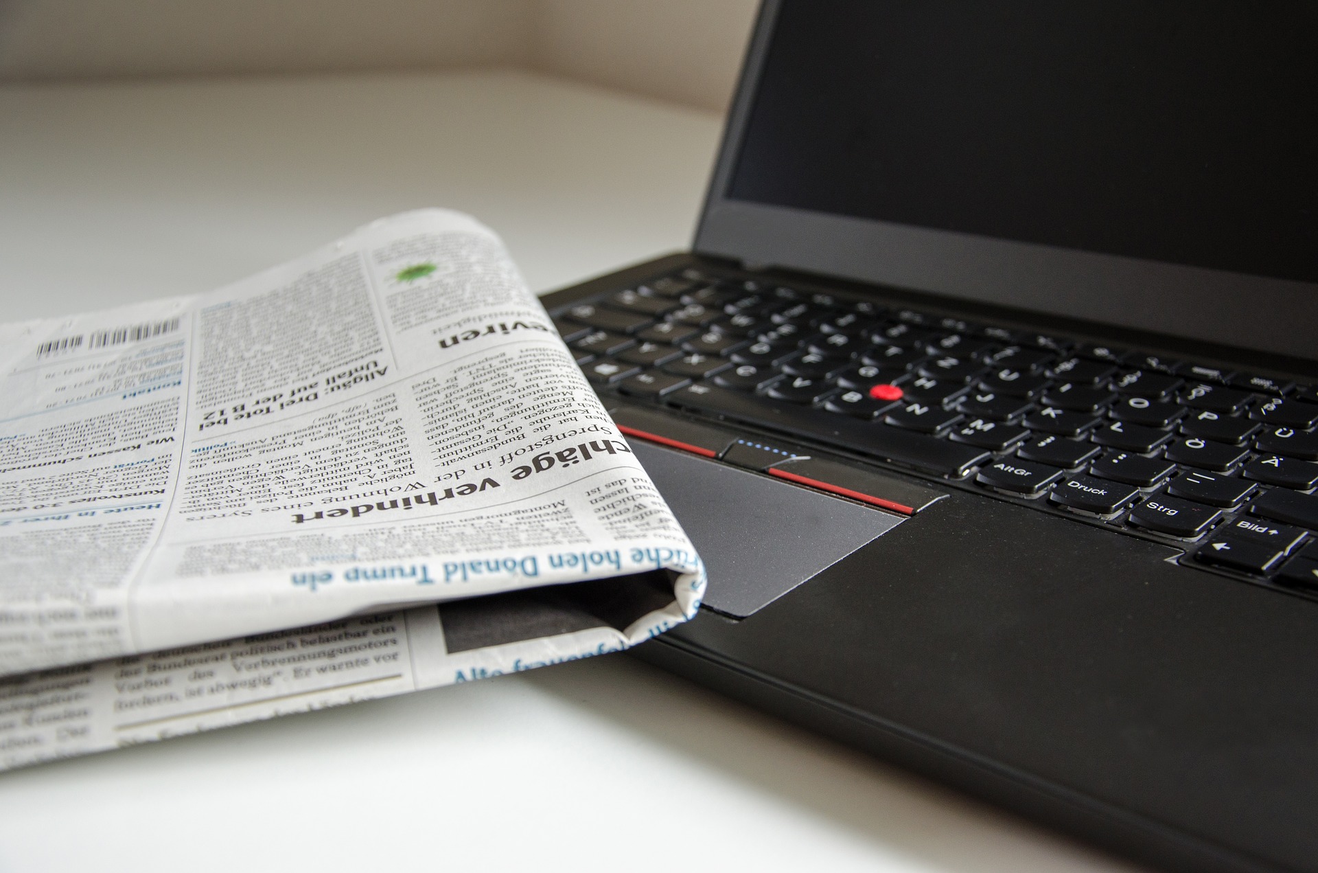 newspaper and a laptop